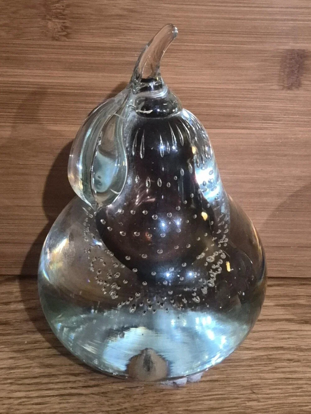 Vintage clear glass pear paperweight featuring controlled bubbles